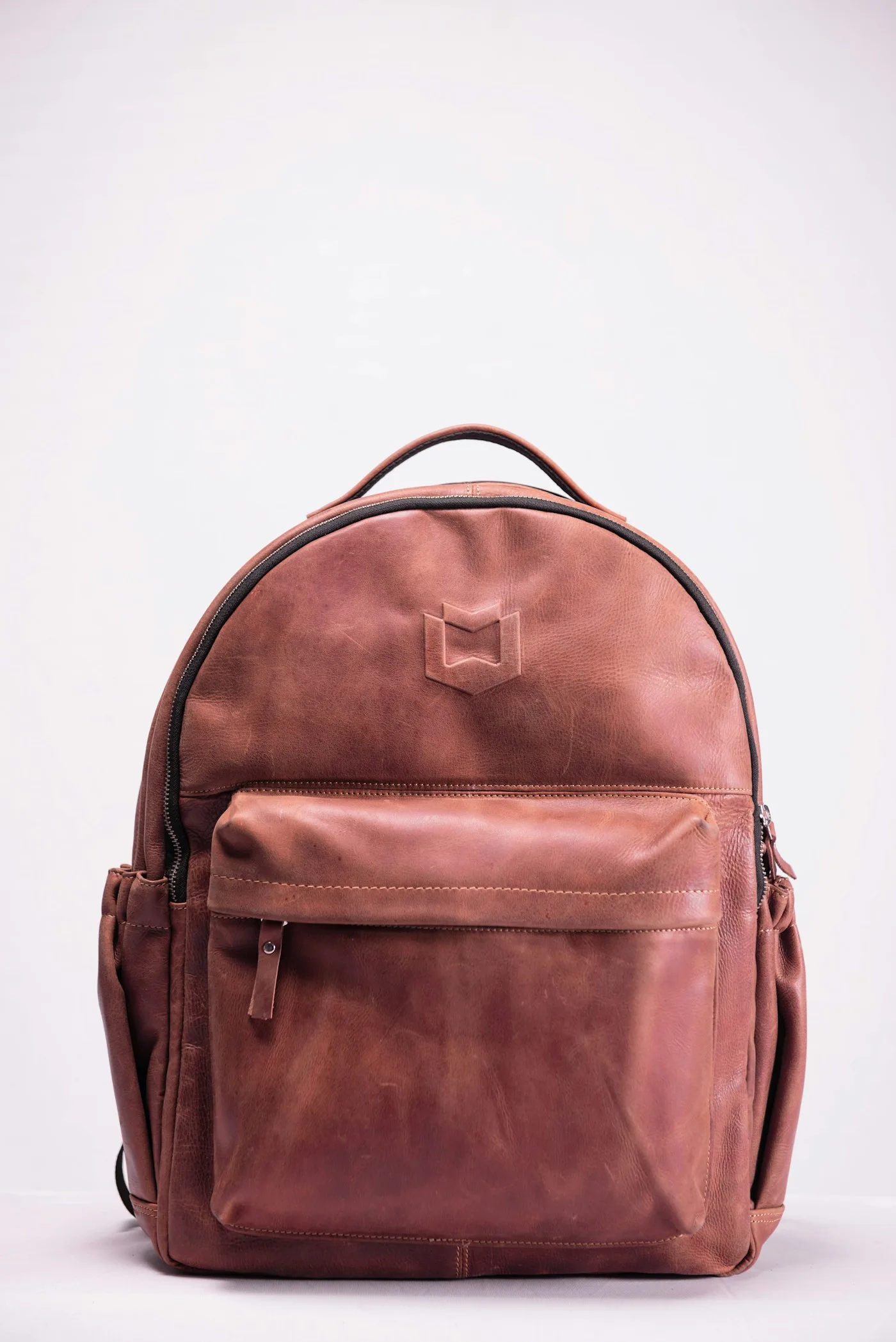 Pink backpack with front pocket and carrying handles